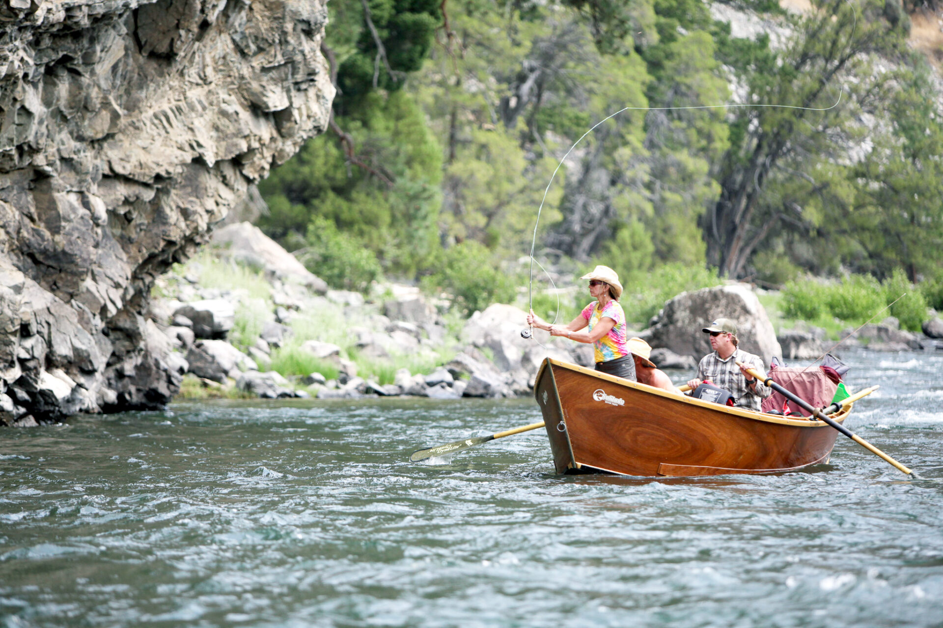 summer fly fishing in a wooden drift boat on the middle fork of the salmon river in idaho