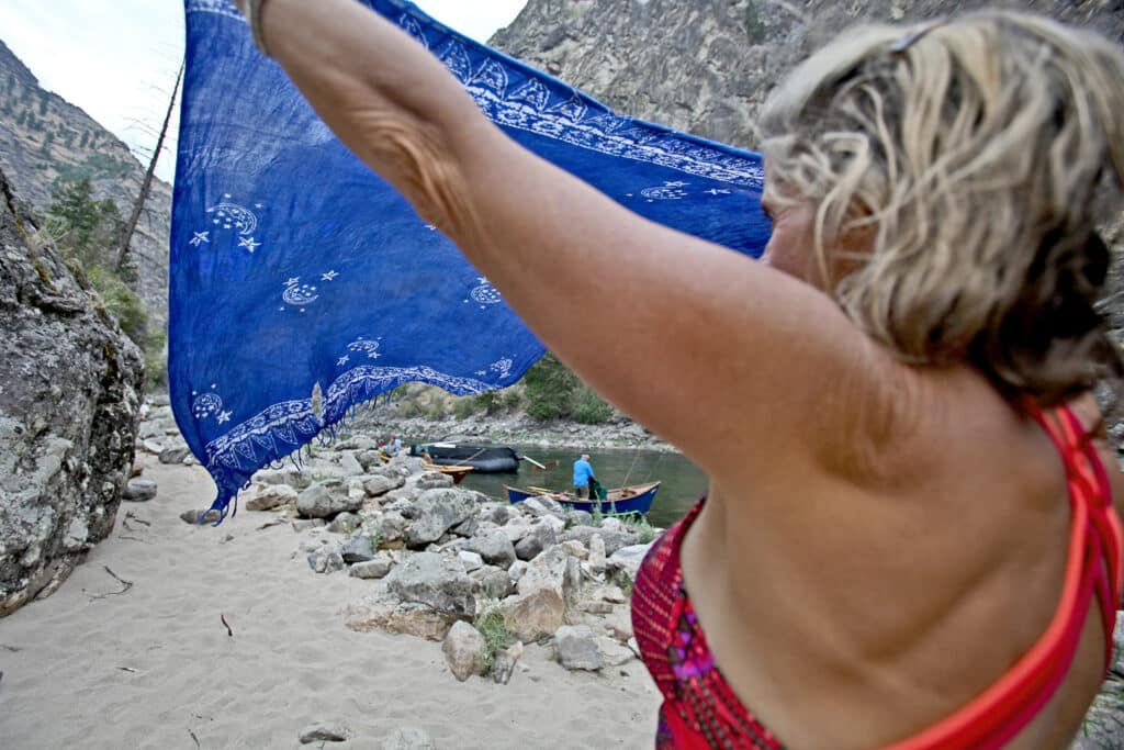 Woman drying her gear at camp.