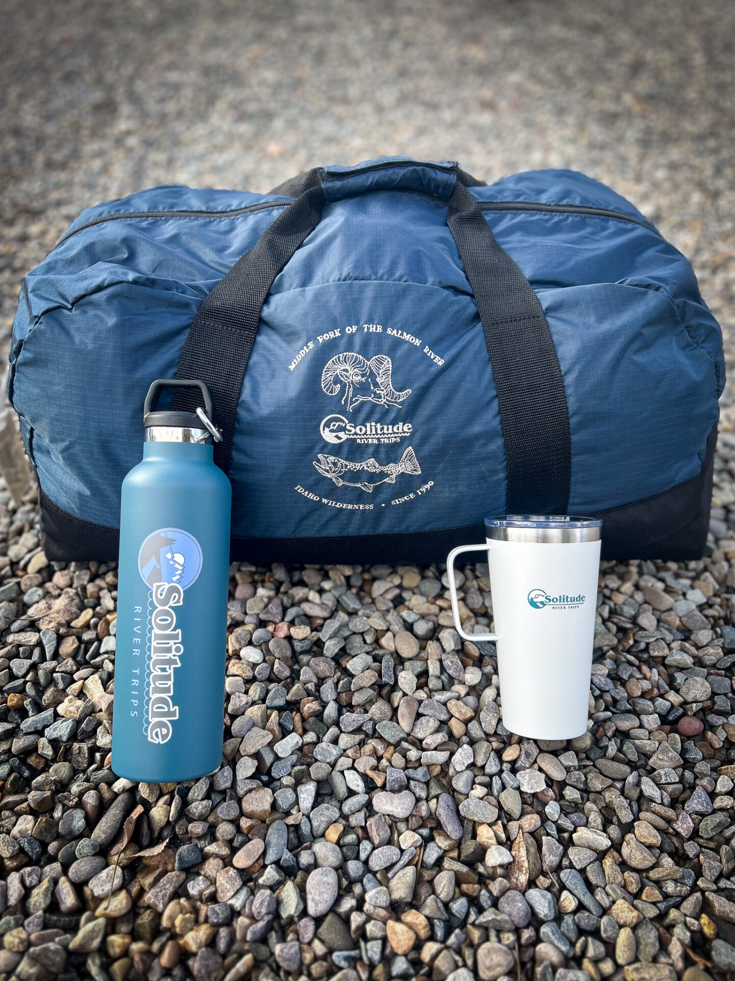 the duffel bag, water bottle and coffee mug solitude river trips provides to each of their guests.