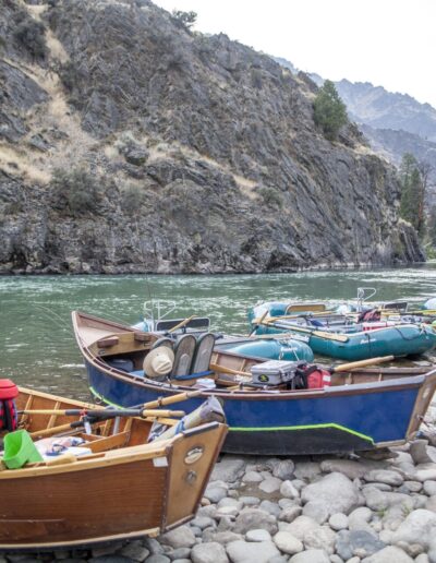 drift boats and fishing rafts lined up on shore