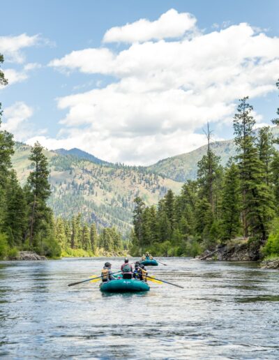 boats floating on calm water down a mountain river in the late season