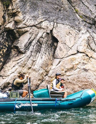 Raft floating past a cliff wall on Idaho's Middle Fork
