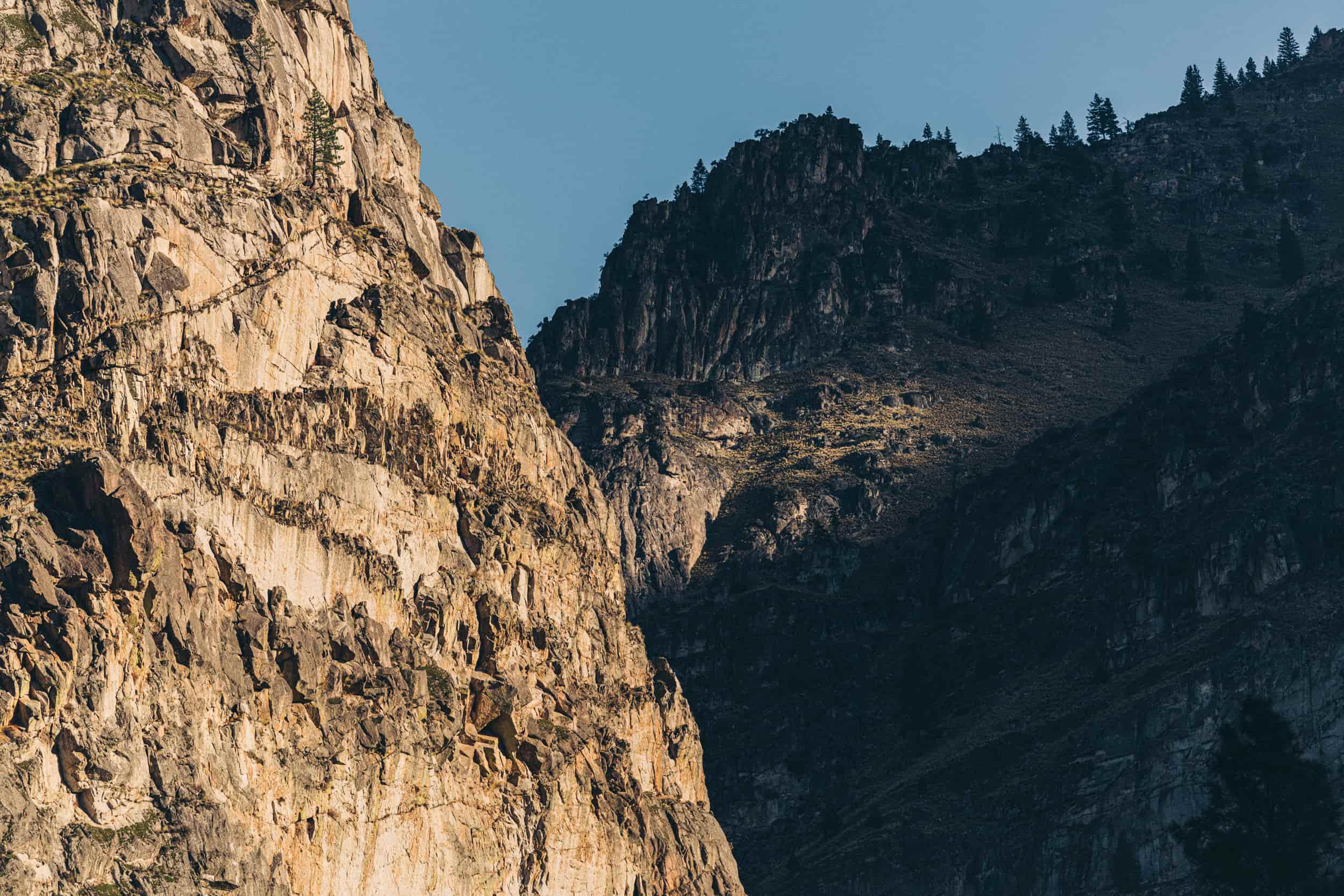 Sunset on tan canyon walls, with shadows lighting up different sections. 